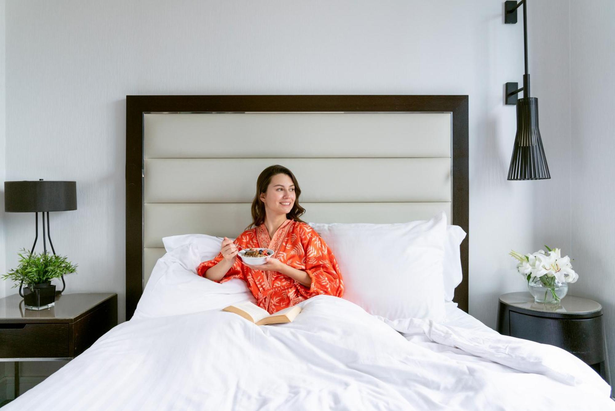 Moevenpick Istanbul Hotel Golden Horn Eksteriør billede A woman sitting on a bed